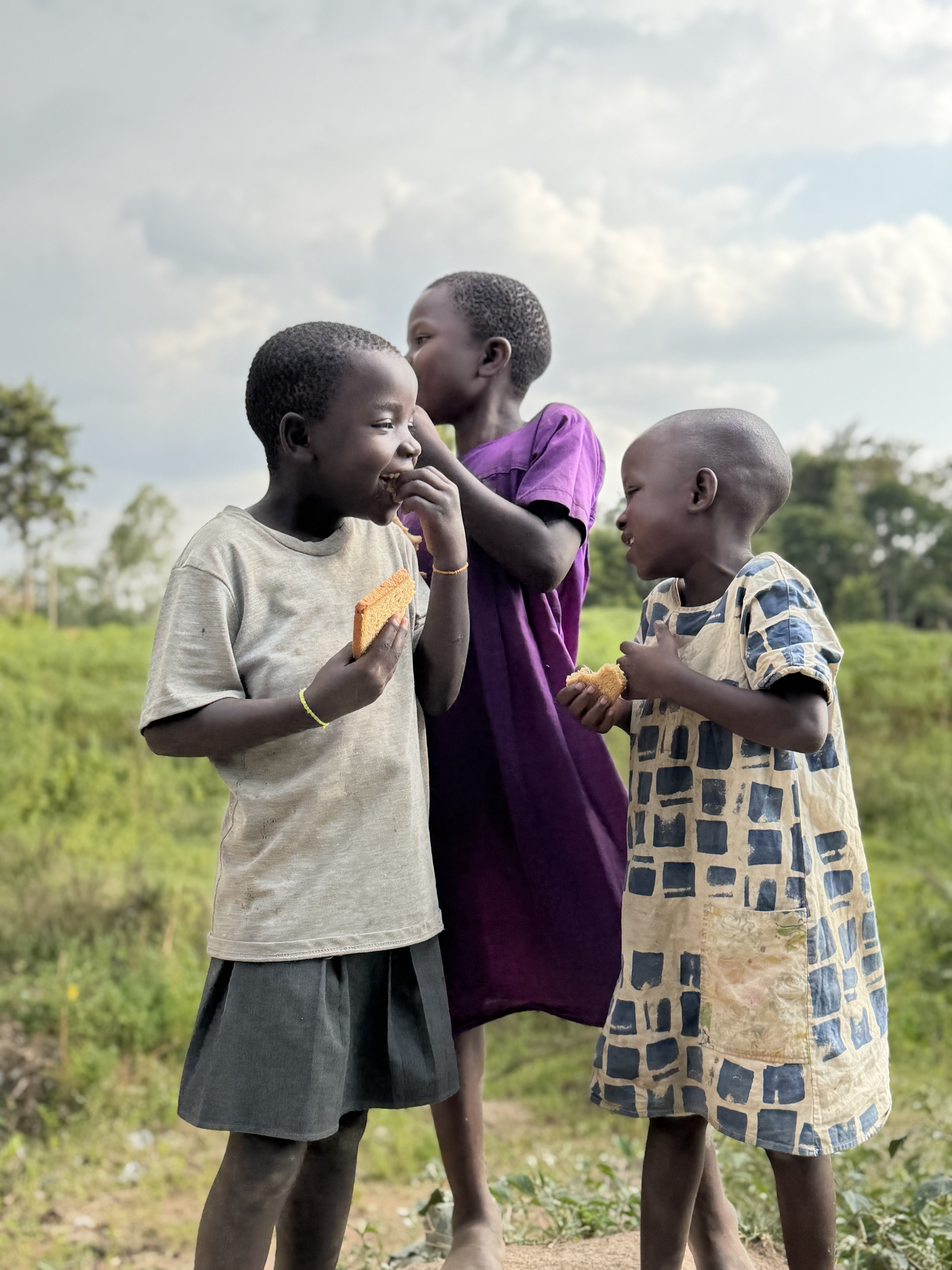 Children smiling in community setting